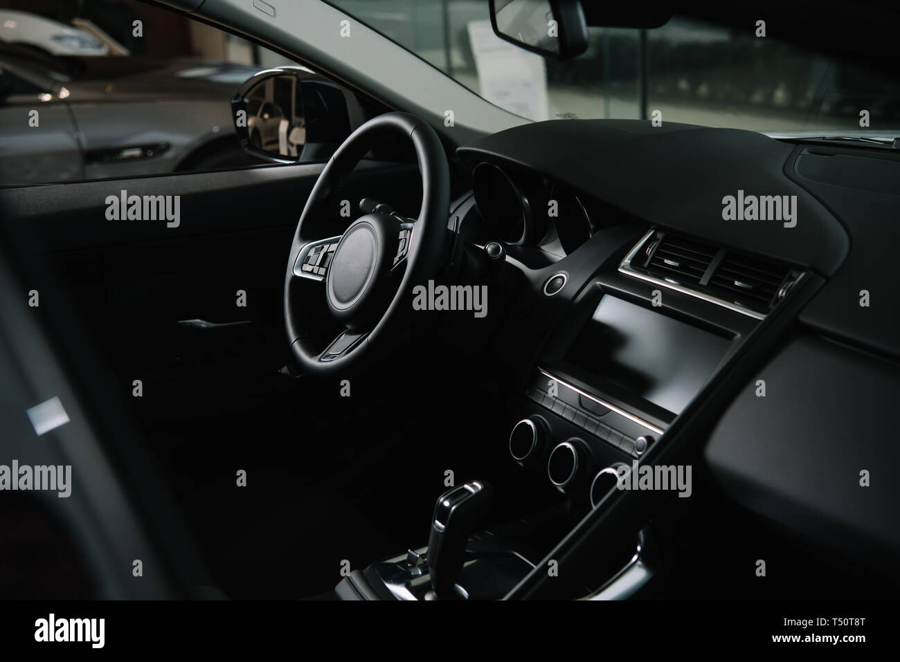 black steering wheel near gear shift in luxury car Stock Photo Alamy