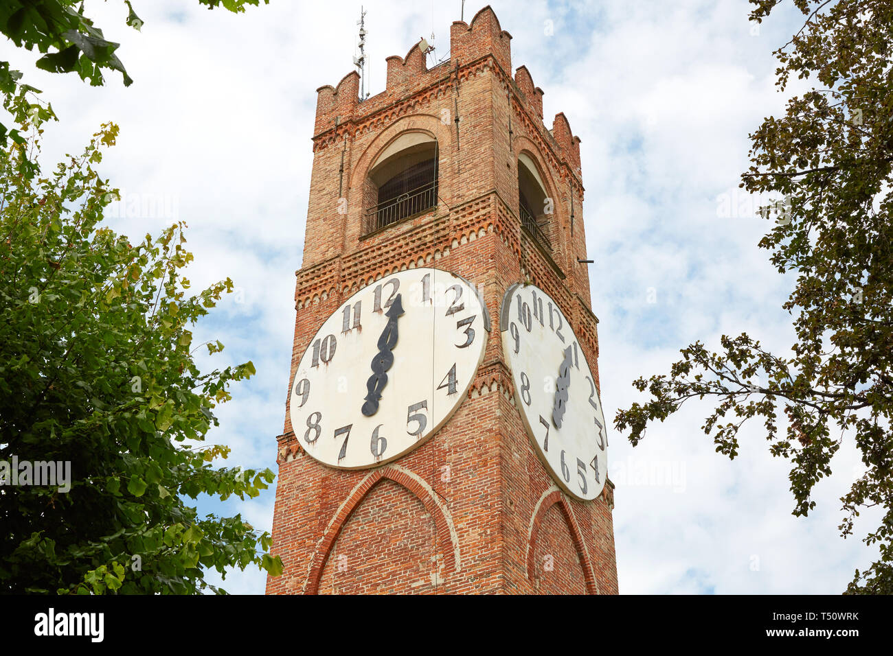 Belvedere ancient clock tower and trees in a summer day in Mondovi, Italy Stock Photo
