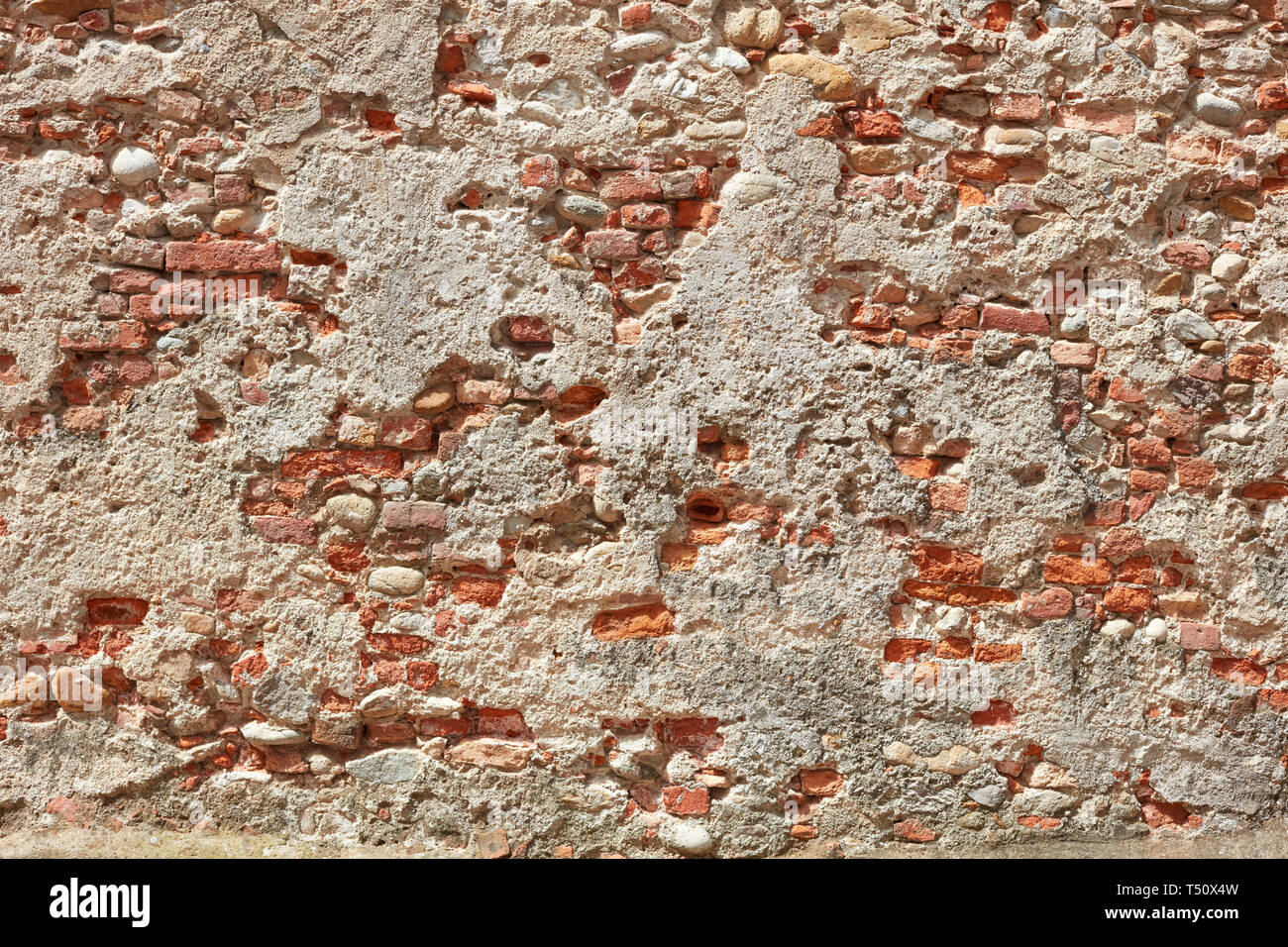 Old bricks and concrete wall texture background, sunlight Stock Photo