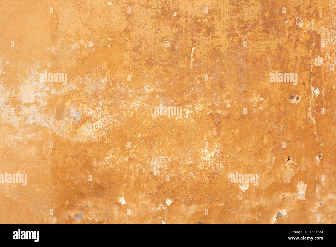 Old yellow faded wall texture background Stock Photo