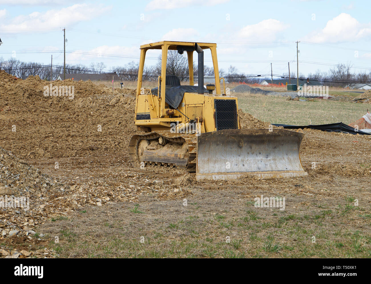 A bulldozer sits idle at a construction site. Stock Photo