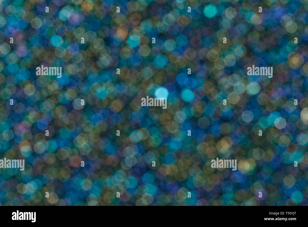 Colorful twinkling lights bokeh blue light background. Stock Photo
