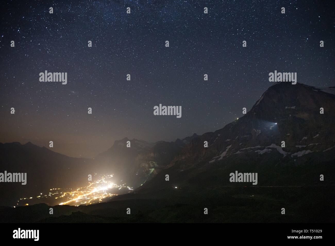Starry sky, night landscape. Grindelwald valley. Eiger mountain peak. Bernese Alps. Swiss Alps. Europe. Stock Photo