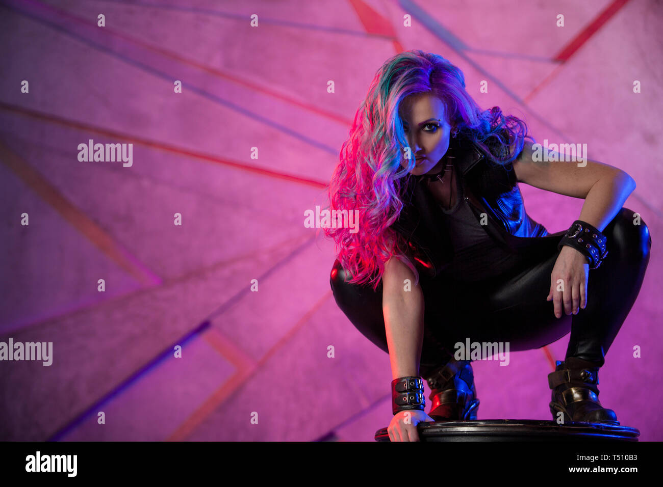 Fashionable Young Woman In Black Leather Clothes And With Colored