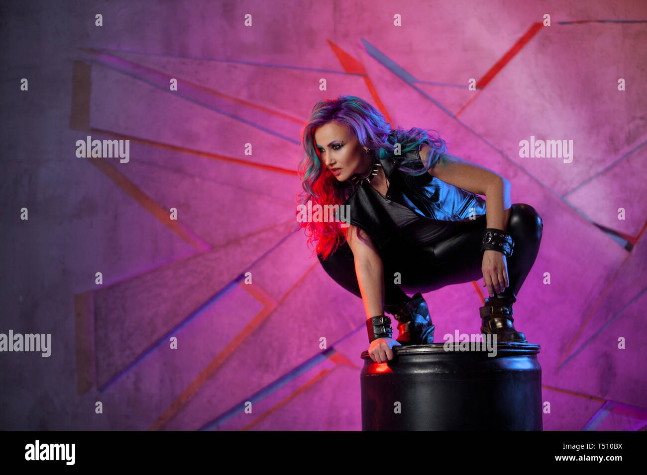 Fashionable Young Woman In Black Leather Clothes And With Colored