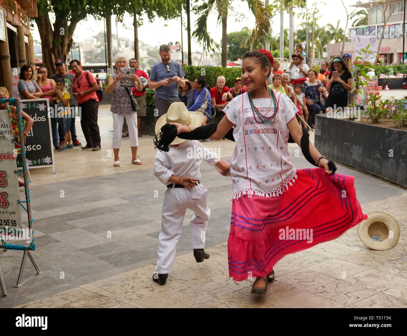 Family of traditional dancers, La Plaza Alvarez (The Zocalo), Acapulco, Mexico. Performing for tourist contributions. Stock Photo