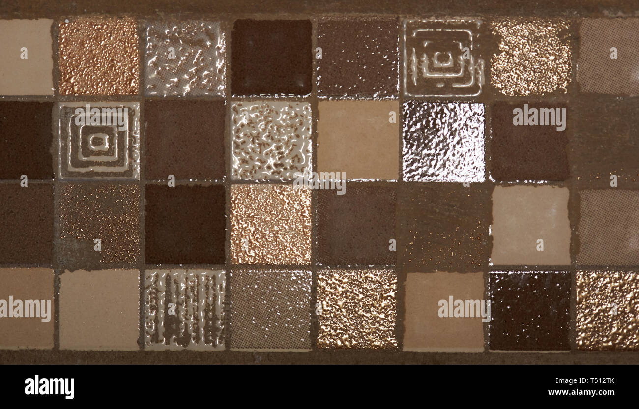 Brown square mosaic tiles on bathroom wall texture background Stock Photo