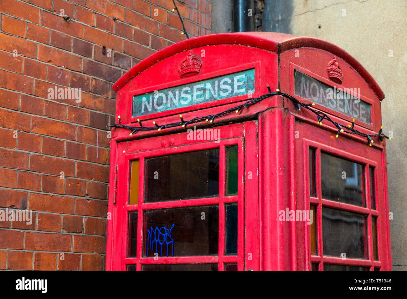 Red Grade II listed telephone box on Pembroke Street with the word Nonsense inscribed, Oxford, UK Stock Photo