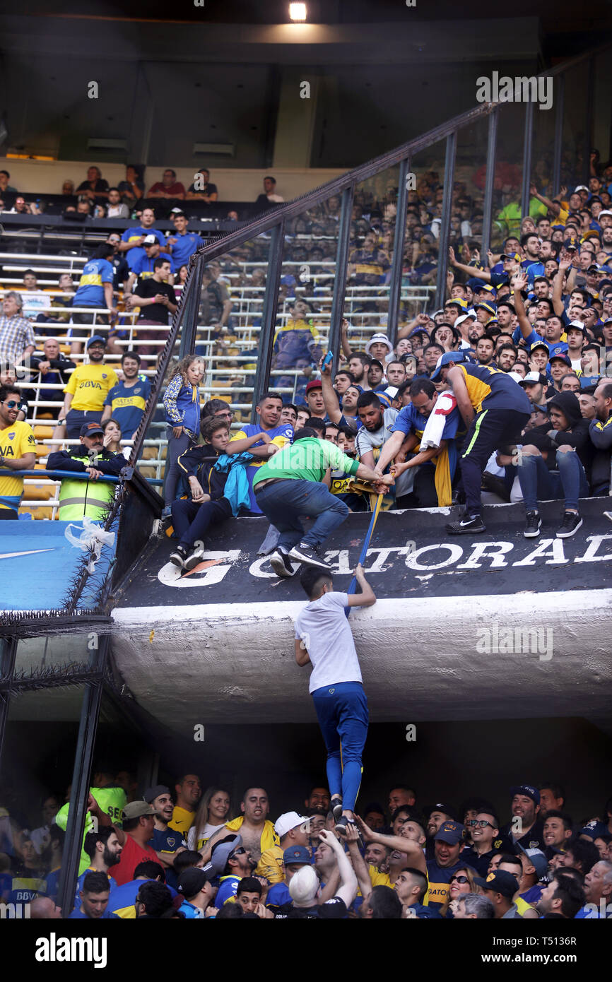 BUENOS AIRES, ARGENTINA - SEPTEMBER 23, 2008: Boca Juniors fans climbing a flag to the upper side of the arena in the Alberto J. Armanado in Buenos Ai Stock Photo