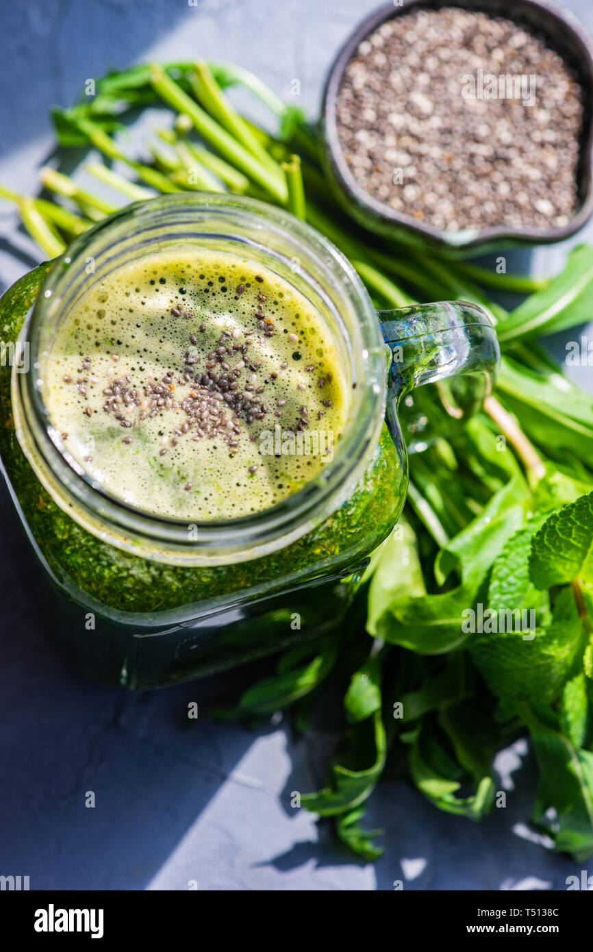 Organic vegetable smoothie with spinach and chia seeds on rustic