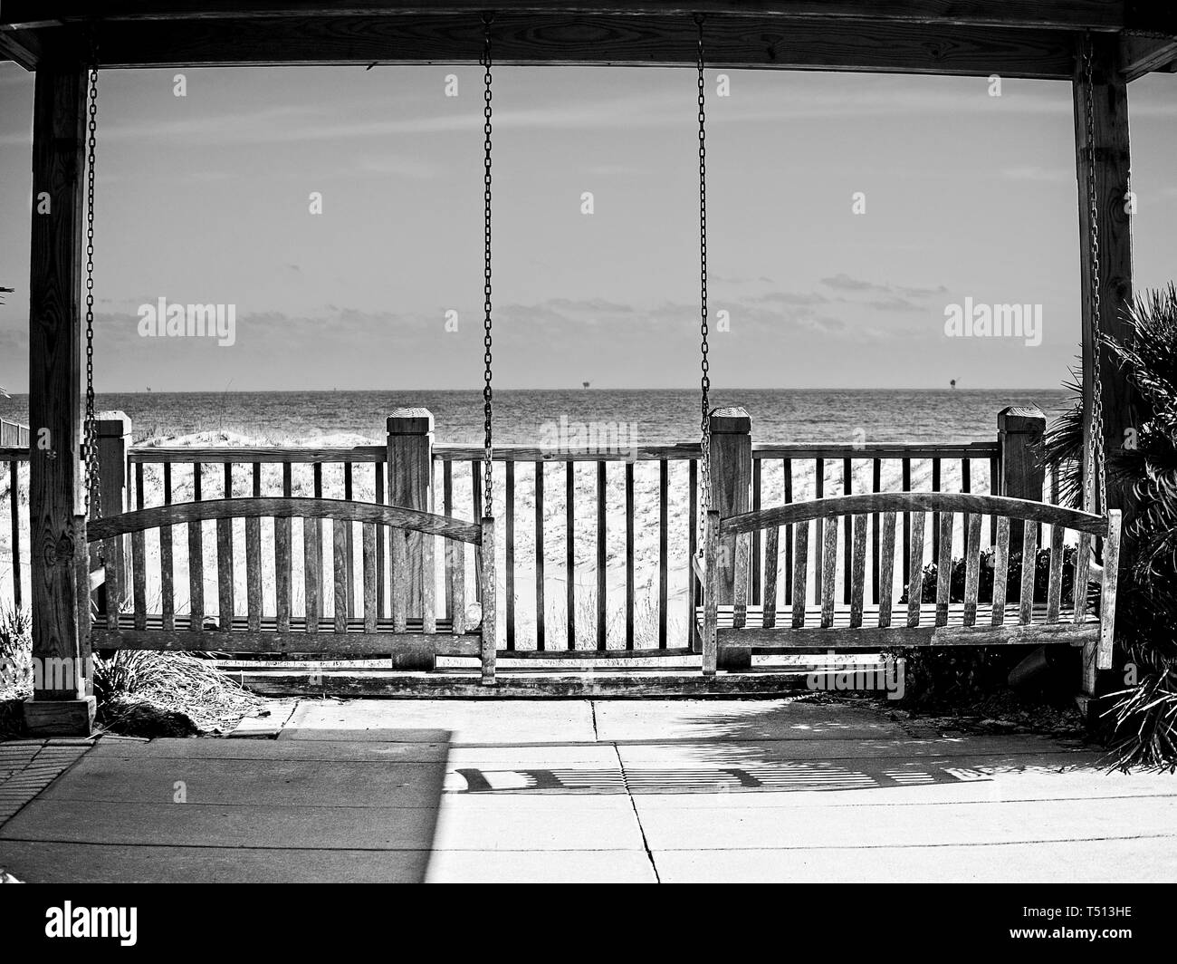 Gulf Shores AL USA 05/04/2018 Two Swing Benches Looking Over Water