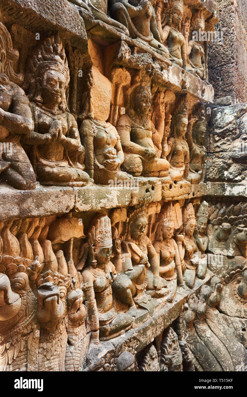 Basrelief engravings of human figures and animals on the walls of the