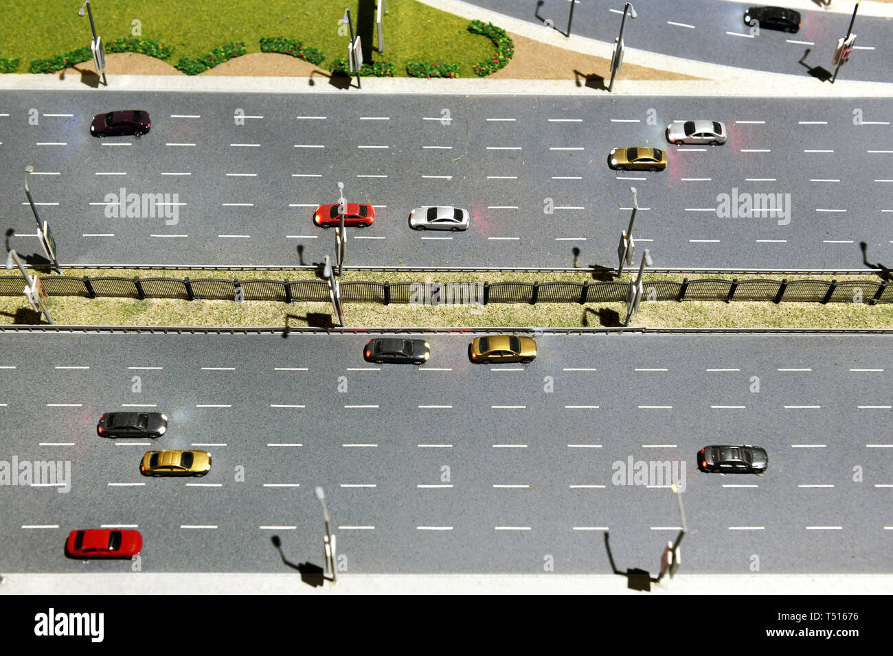 Model of a multi lane highway or motorway with cars travelling in both directions and central median Stock Photo