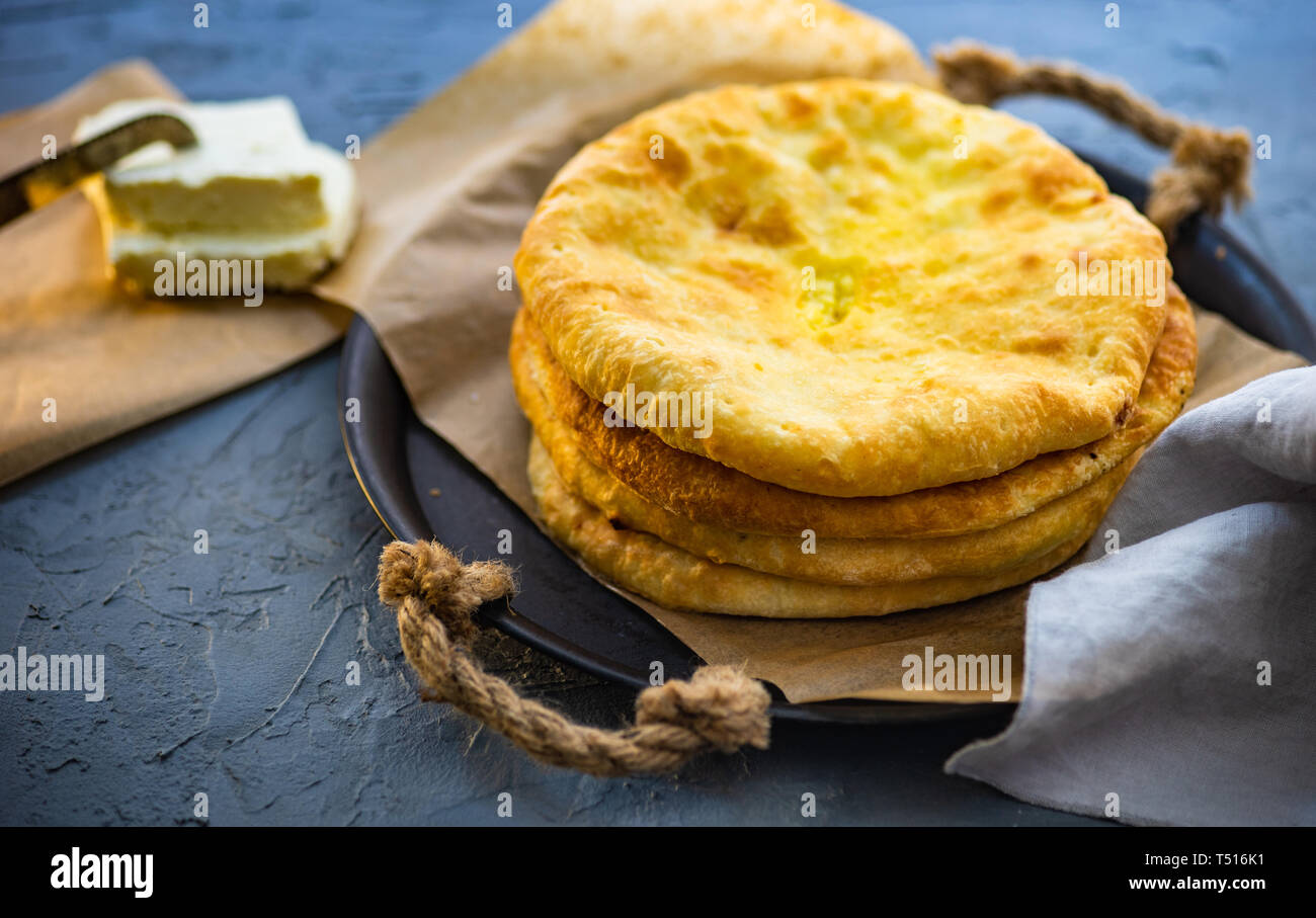 Traditional georgian cheese pie - imeruli khachapuri on rustic background Stock Photo