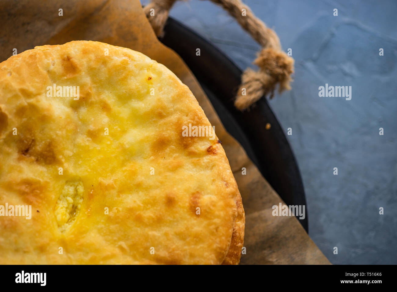 Traditional georgian cheese pie - imeruli khachapuri on rustic background Stock Photo