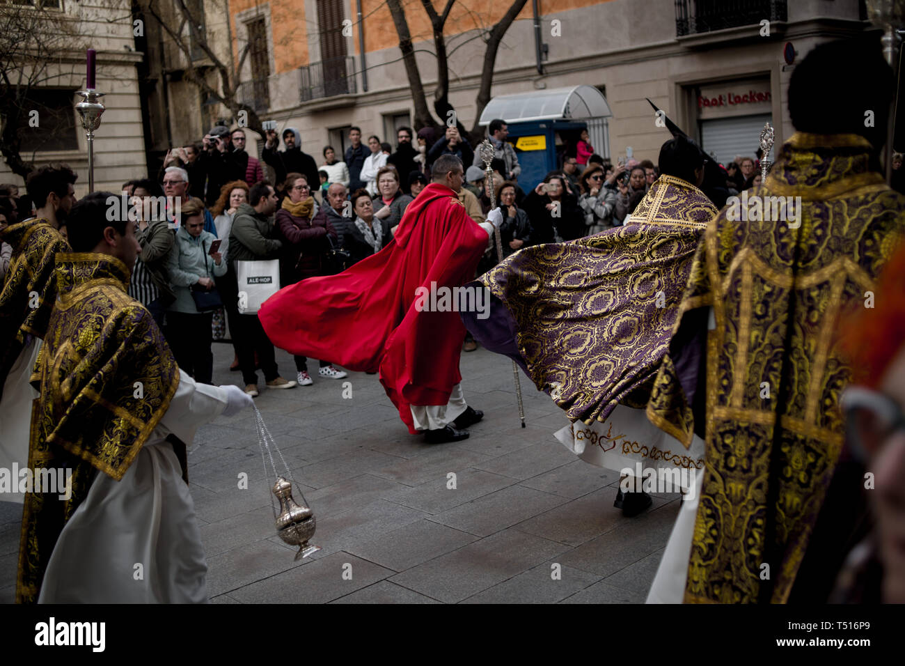 The wind blows the robes of the priests during the Good Friday procession in Barcelona. Stock Photo
