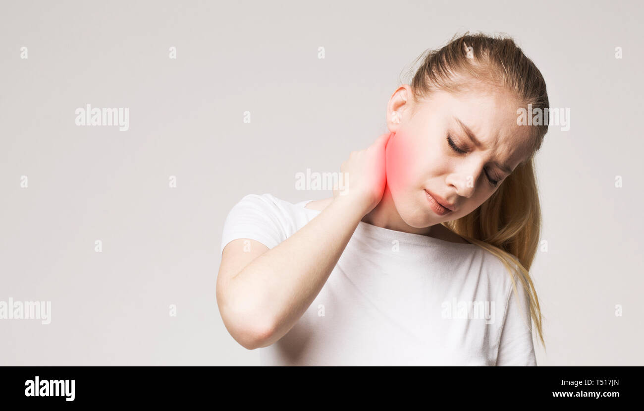 Tired woman massaging her painful neck, panorama Stock Photo - Alamy
