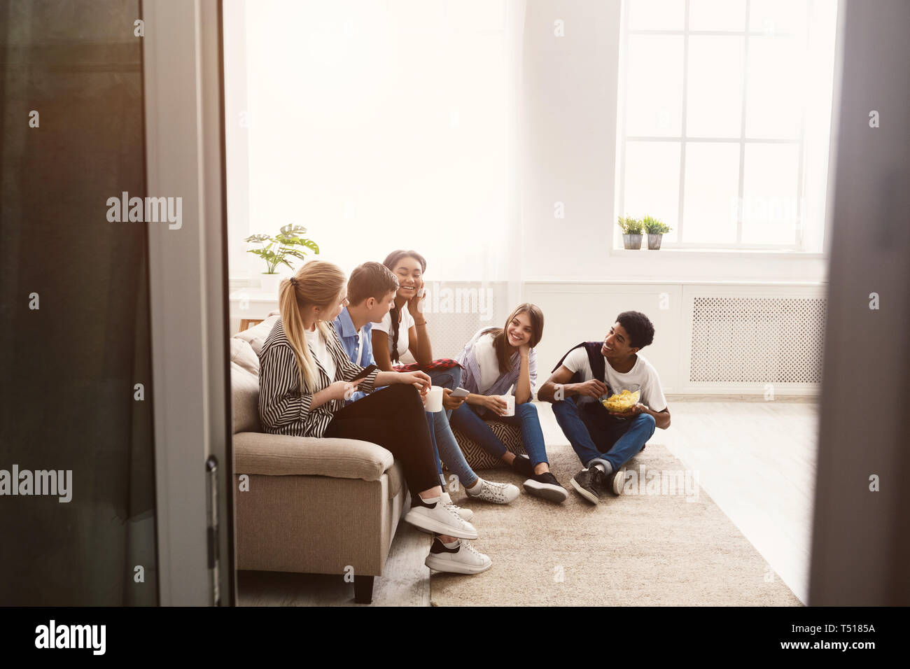 Happy students spending time together and talking Stock Photo
