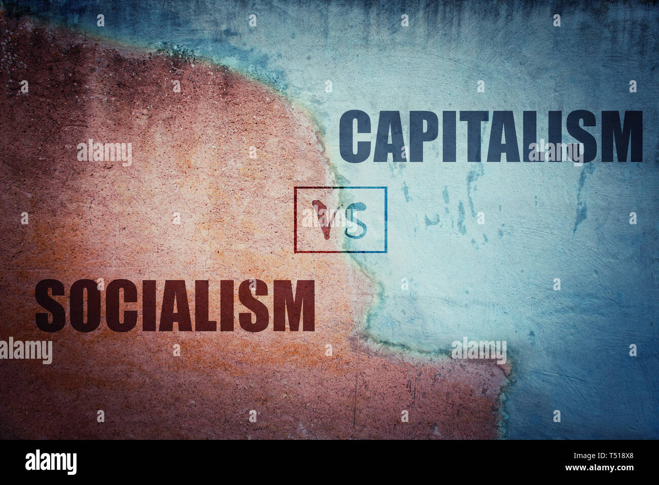 Socialism versus capitalism split concrete wall cracked in two different halves, red and blue side. Socialist centralized economic planning vs capital Stock Photo