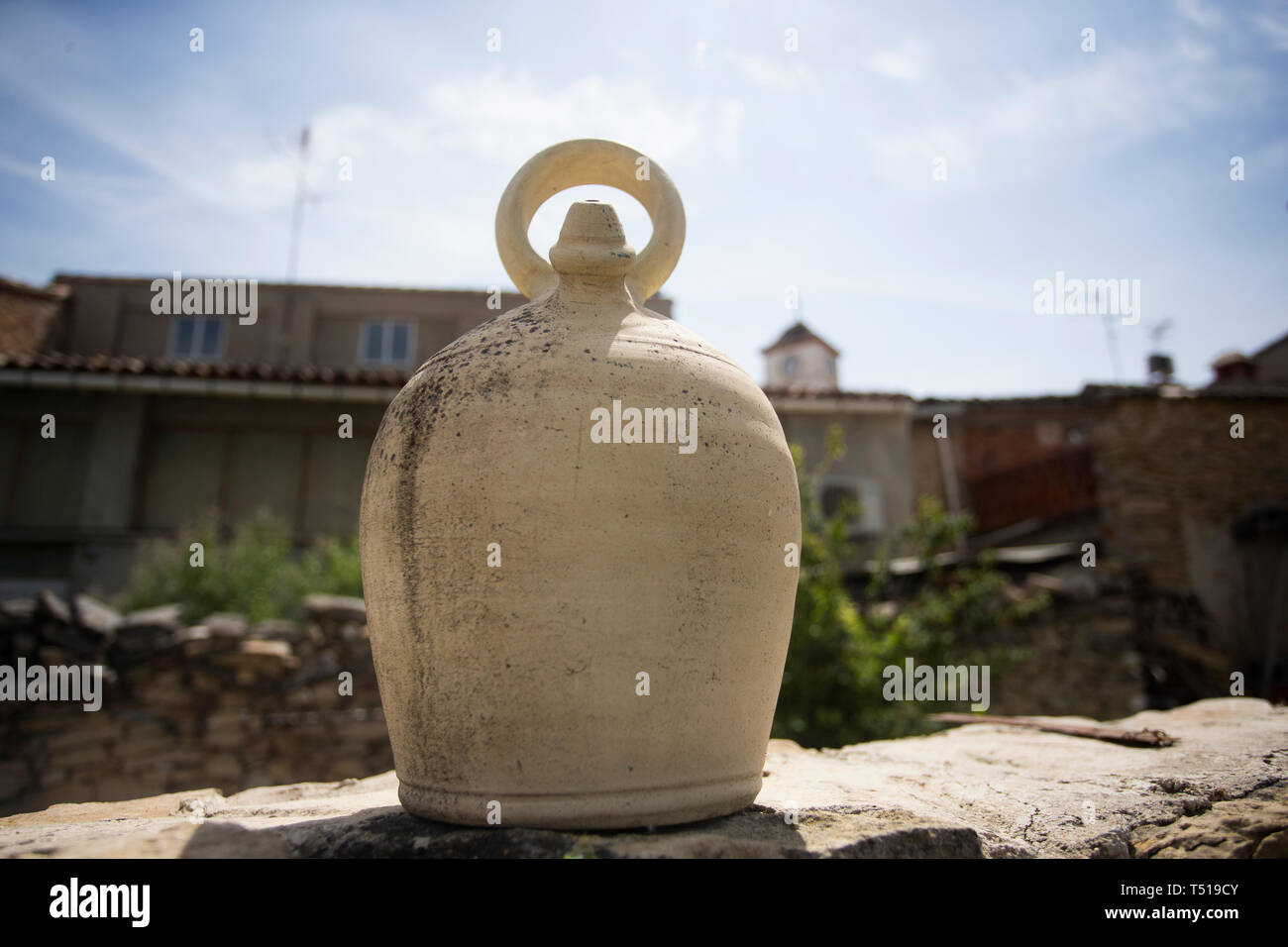 Large ceramic spanish clay jug resting on a wall. Stock Photo