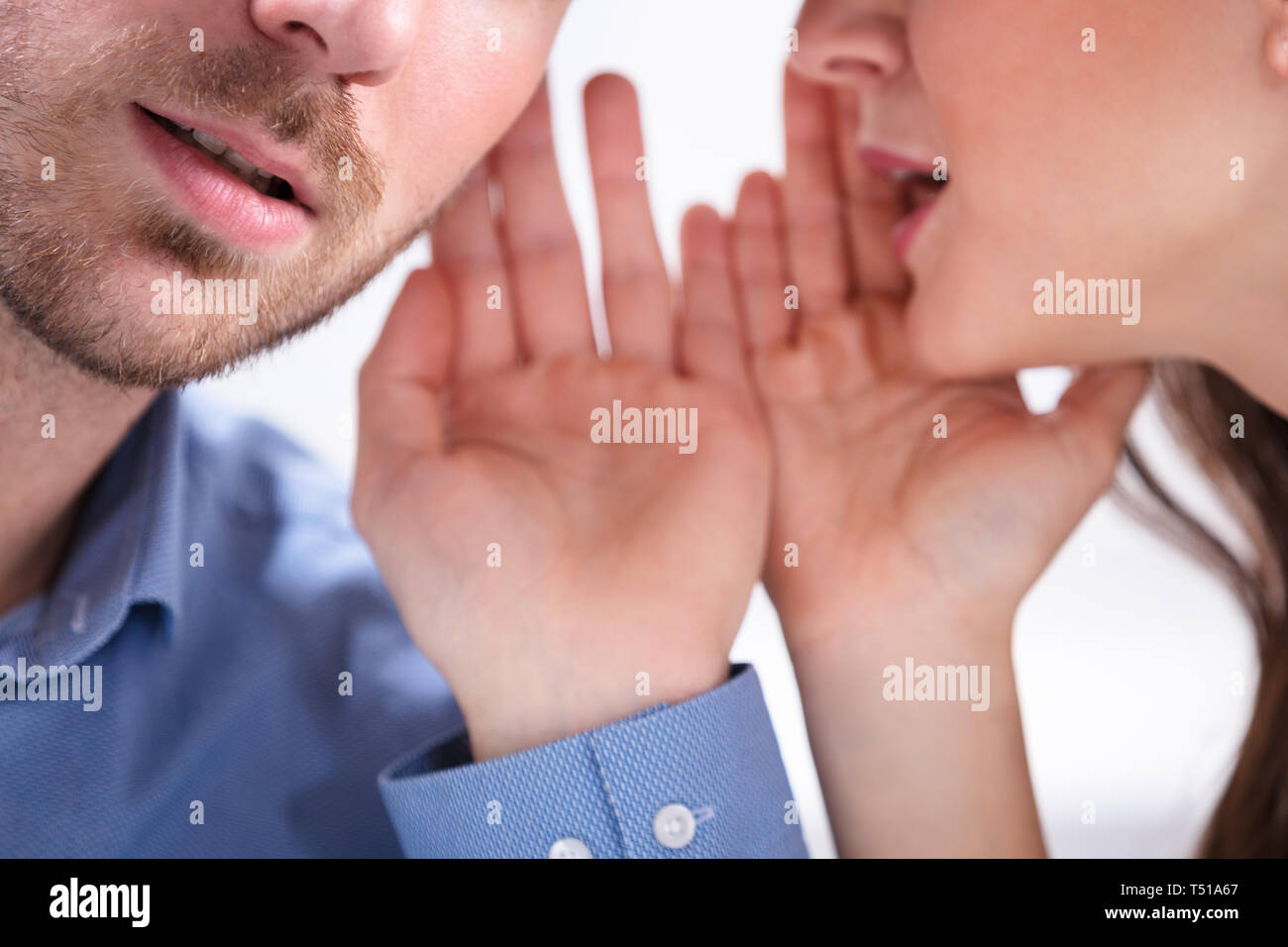 Man whispering in woman ear hires