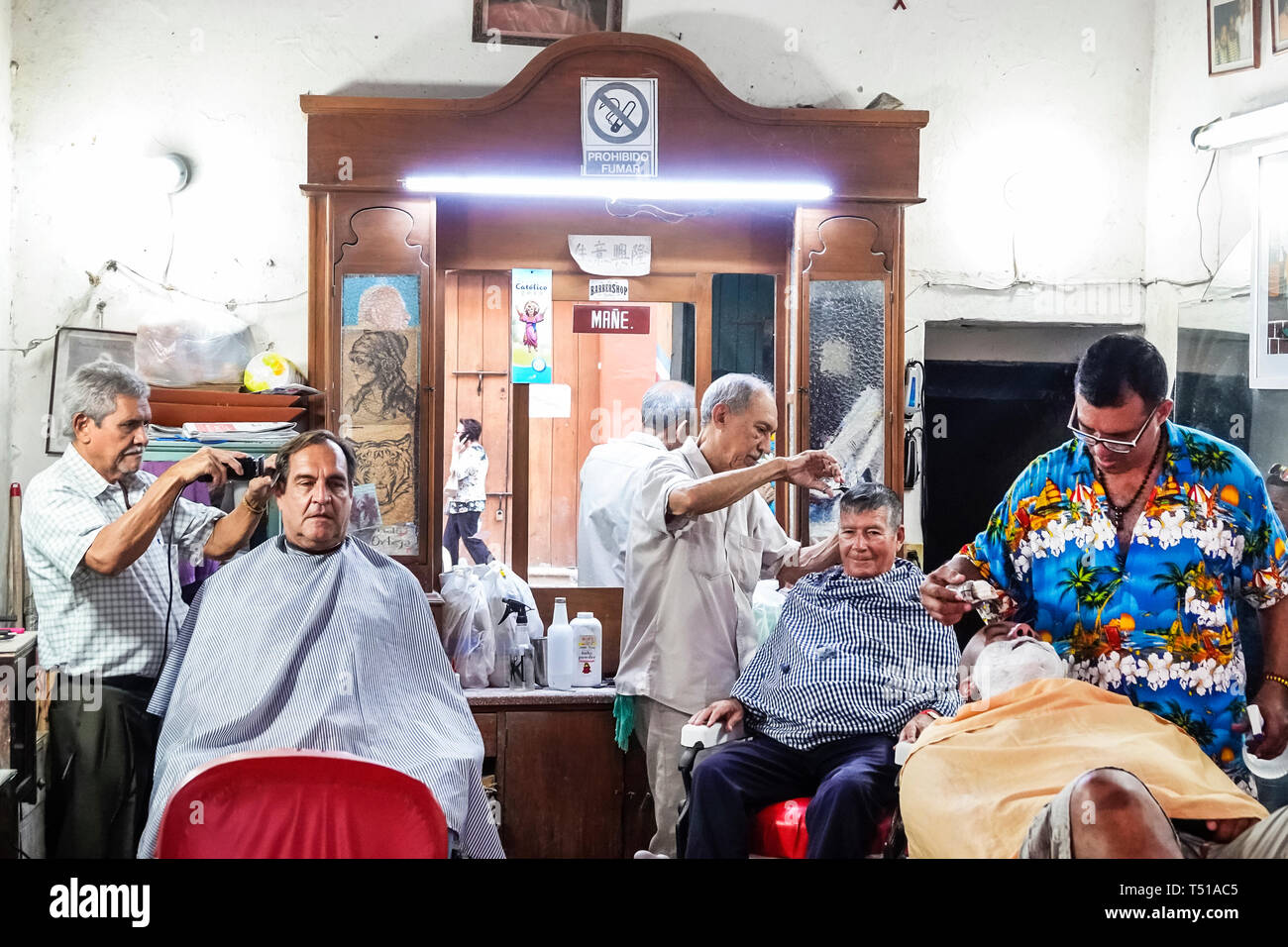 Cartagena Colombia,Hispanic resident residents,man men male,inside barbershop,barbers customers,cutting hair,shaving,COL190123105 Stock Photo