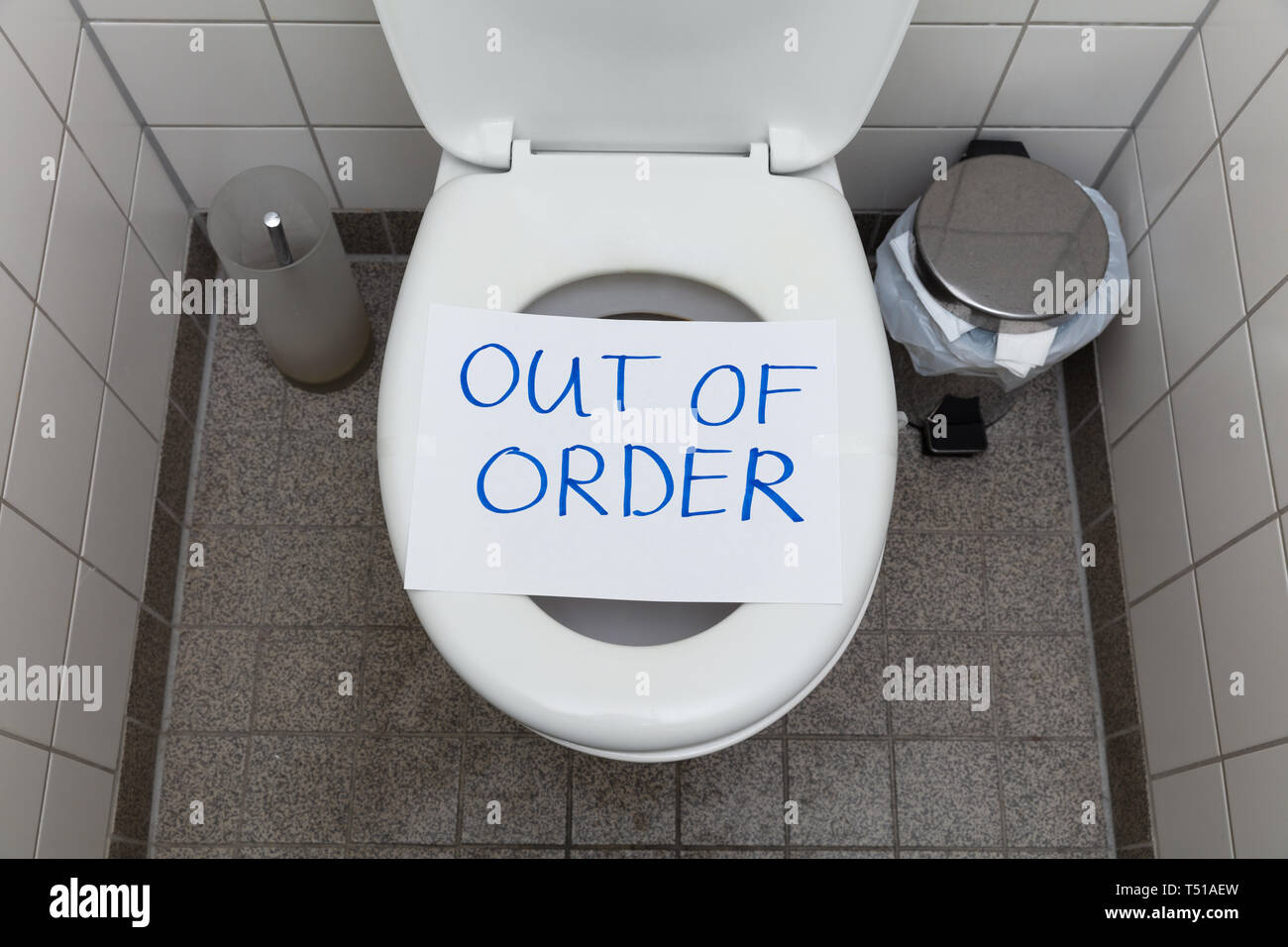 Written Text Out Of Order Message On Paper Over Toilet Bowl In Bathroom Stock Photo