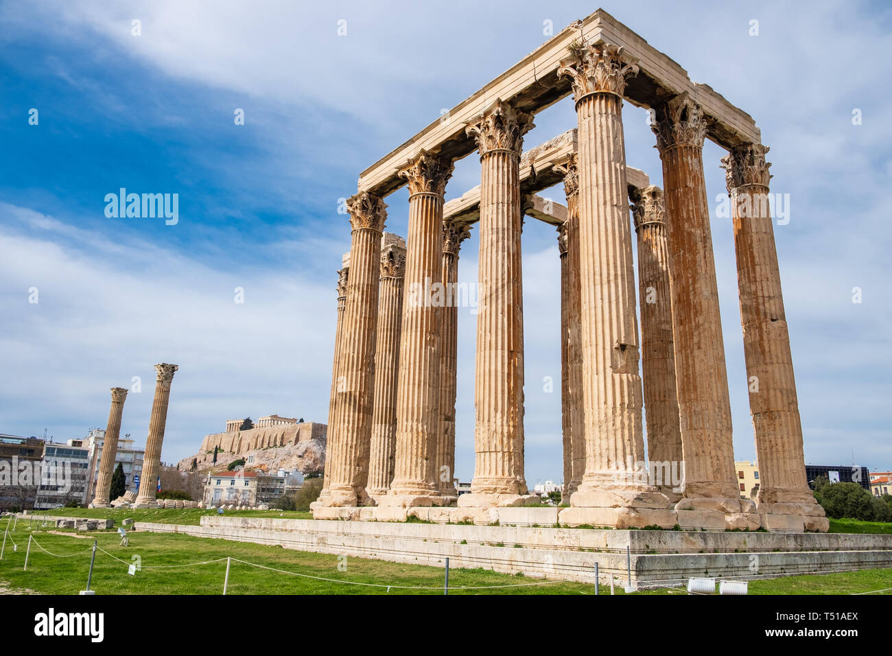 Ruins of the ancient Temple of Olympian Zeus in Athens (Olympieion or Columns of the Olympian Zeus) with Acropolis hill in the background Stock Photo