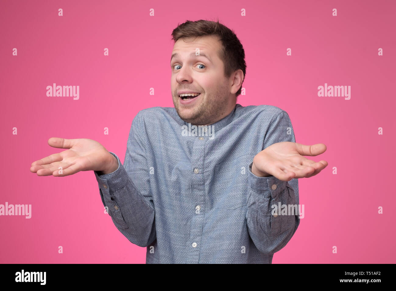 guy showing I have no idea gesture, shrugging shoulders and raising hands Stock Photo