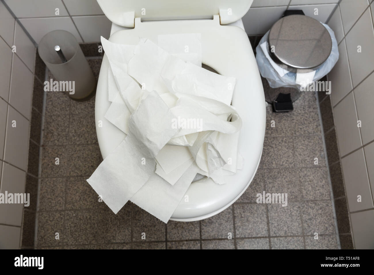 An Overhead View Of Used Crumpled White Toilet Paper Inside The Toilet