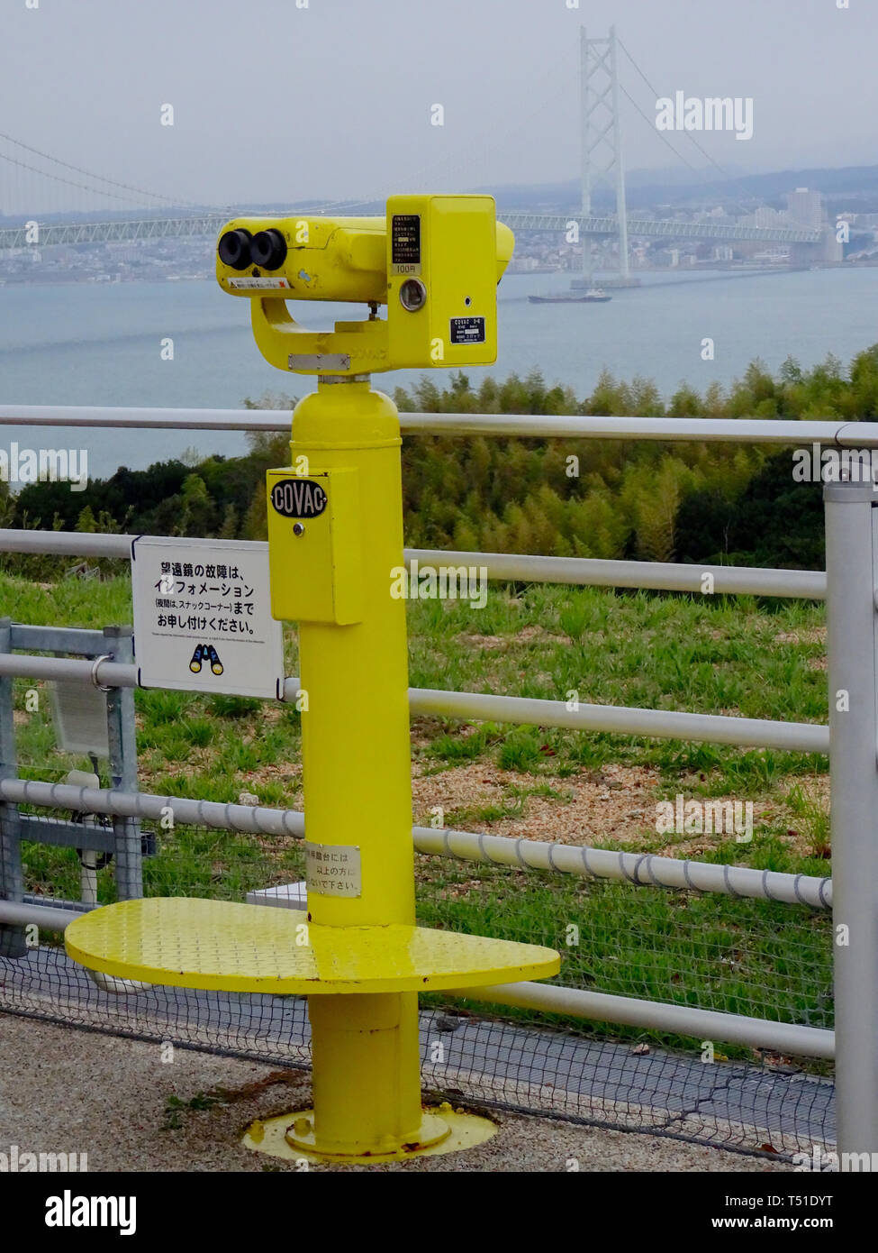 Awaji, Hyogo, Japan - 17th September 2018 : Close up picture of a yellow tourist binocular at Awaji Service Area for Sumoto with the Akashi Kakyo Brid Stock Photo