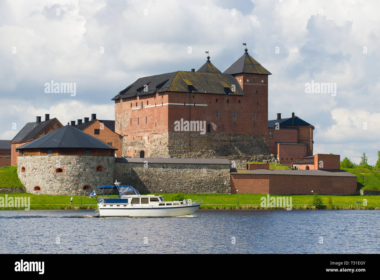 HAMEENLINA, FINLAND - JUNE 10, 2017: The boat on the Vanayavesi  lake against the background of the Hameenlinna fortress Stock Photo
