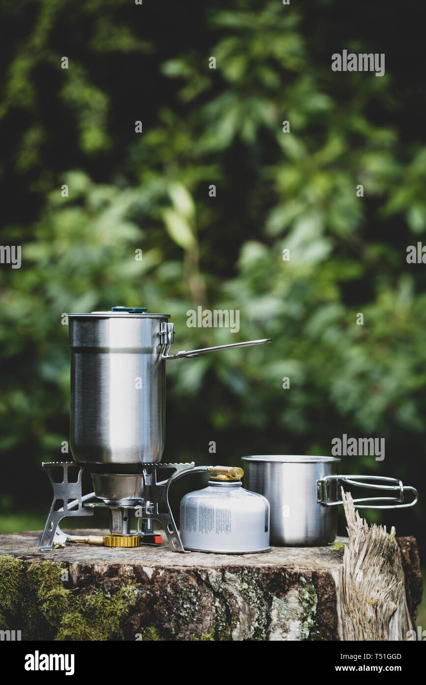 Stainless steel camp mug on a gas stove Stock Photo Alamy