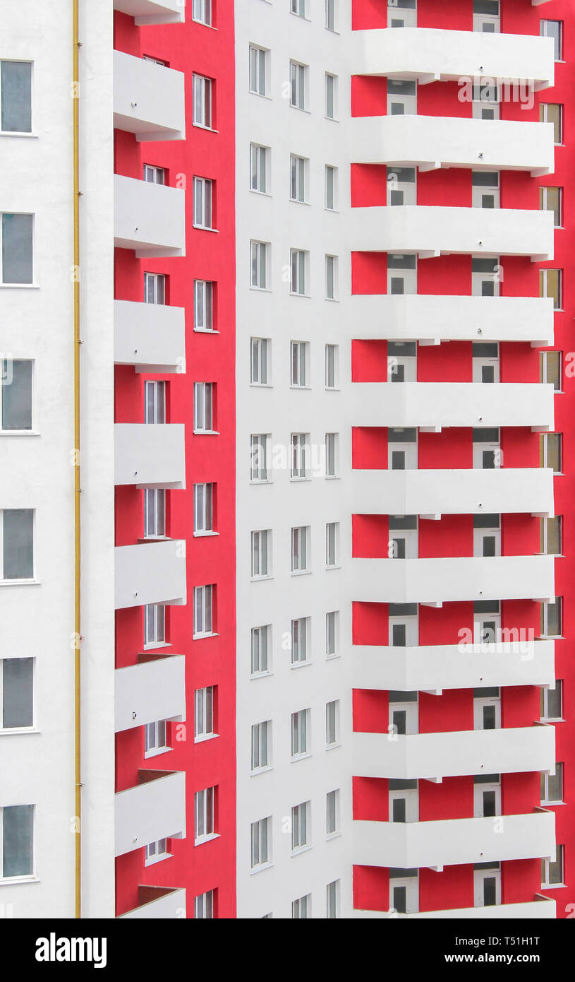 The new built high-rise white-red apartment building Stock Photo - Alamy