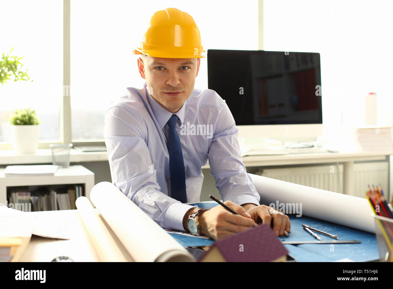Young Architect Freelance Man Working on Blueprint Stock Photo