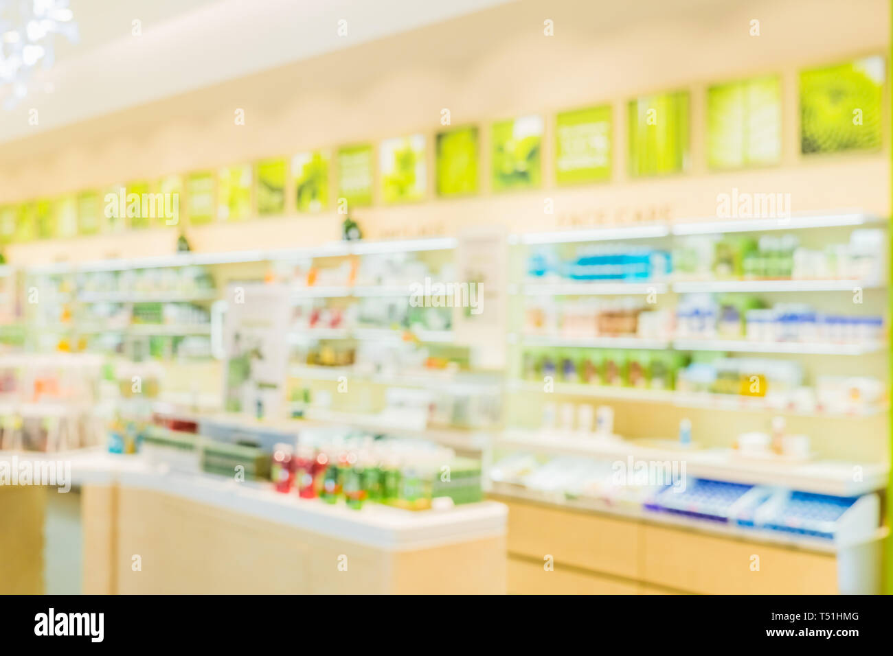 Blurred image of geen nature eco-friendly hygiene cosmetic shelf in a cosmetic shop for background. Stock Photo