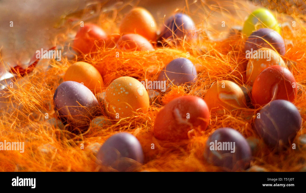 Multicoloured Painted Easter eggs in decorative mesh.Spring Christian concept. Stock Photo