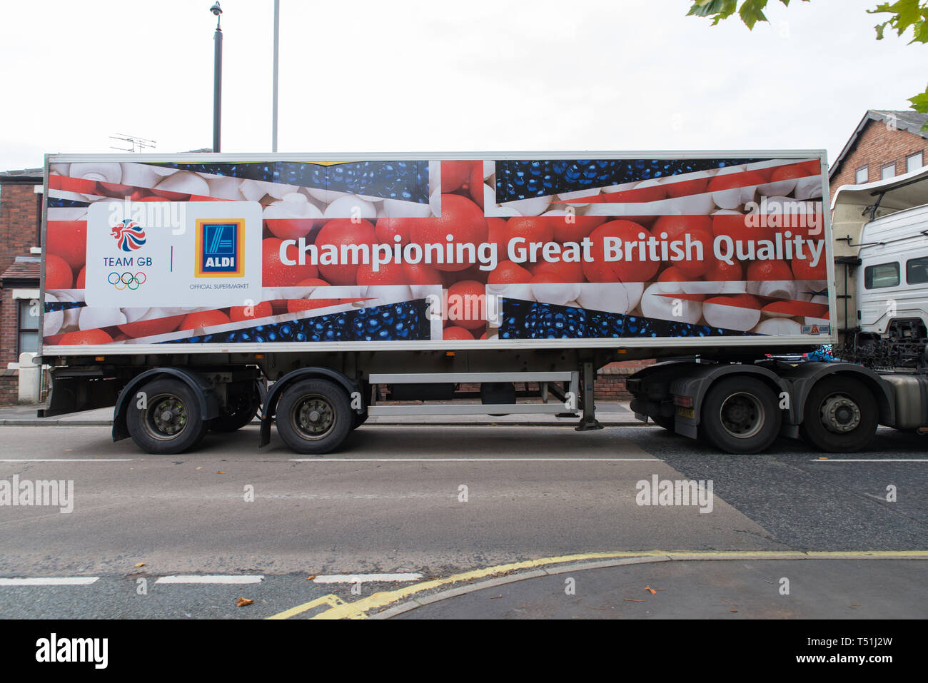 An Aldi - a German supermarket brand - truck passing through Omskirk, West Lancashire, with an image championing British products, Great Britain. Stock Photo