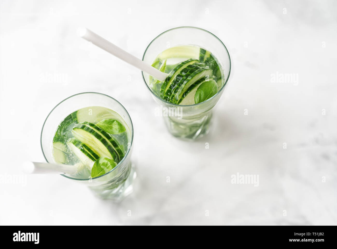 Detox infused water with cucumber and basil. Top view Stock Photo