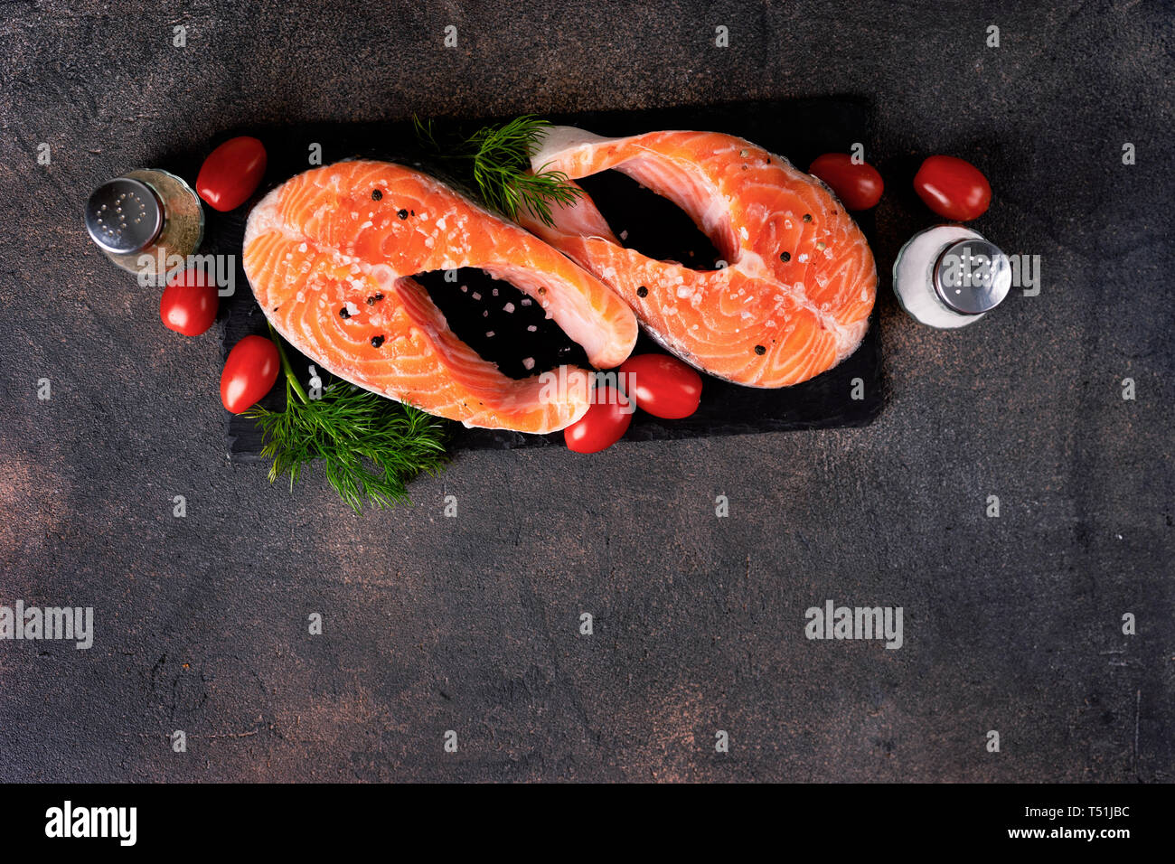 Fresh two raw salmon steaks on dark background Stock Photo - Alamy