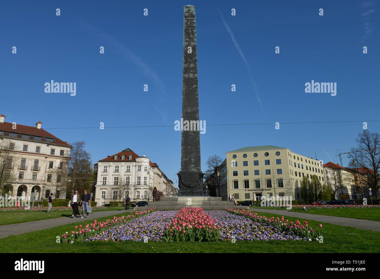 Obelisk with flower beds in front of houses roundabout, Karolinenplatz, Munich, Bavaria, Germany Stock Photo