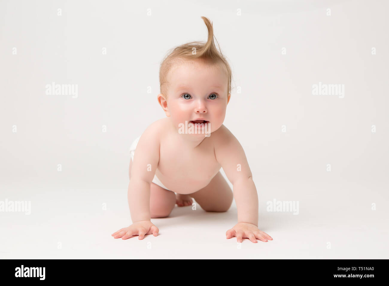 Cute little baby in diapers crawling on white background,bright picture