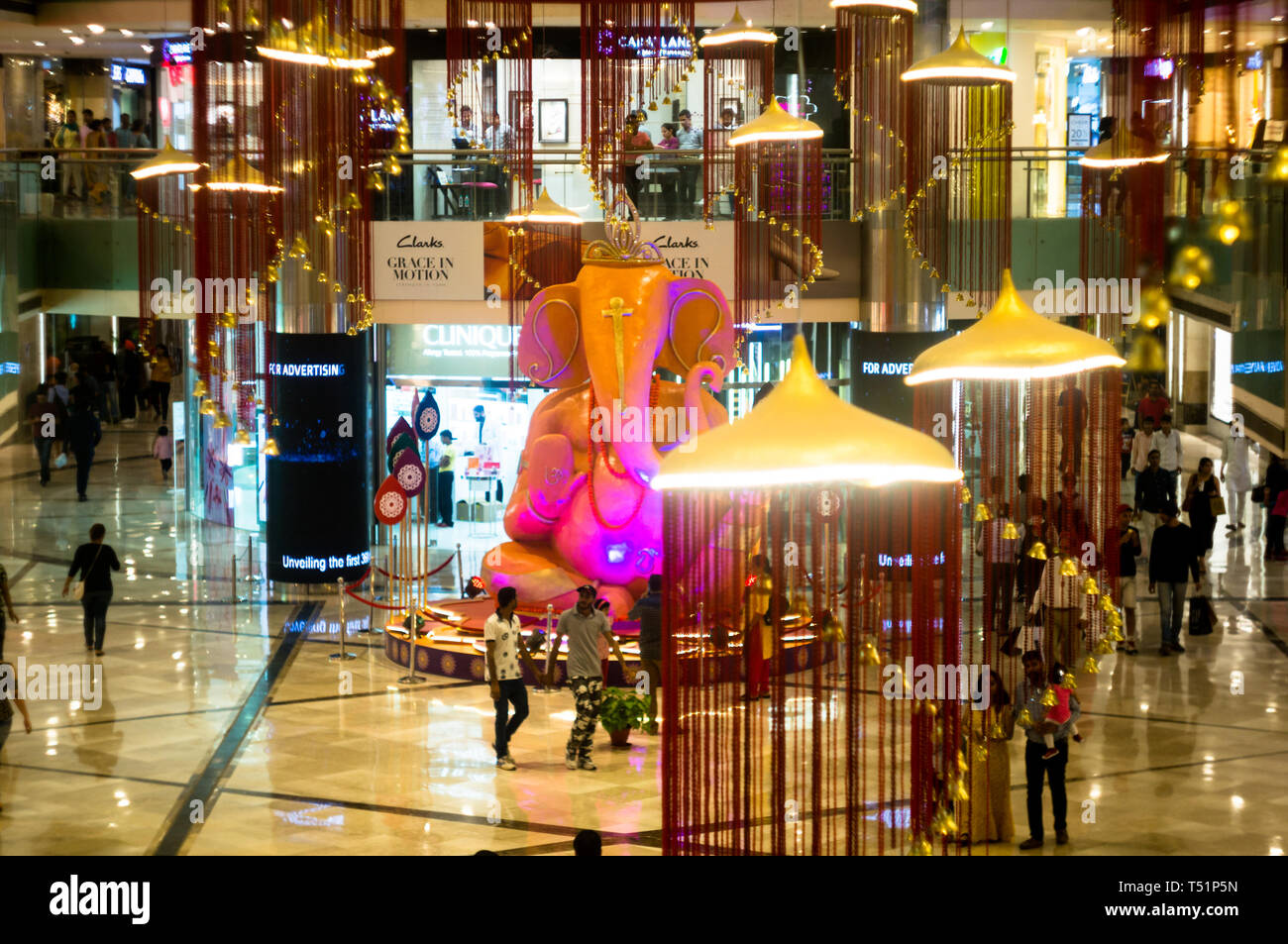 Delhi, India - Circa 2019 : Massive statue of hindu god ganesha on the eve of Ganesh Chaturti. The new shopping malls with multiple brand outlets are  Stock Photo
