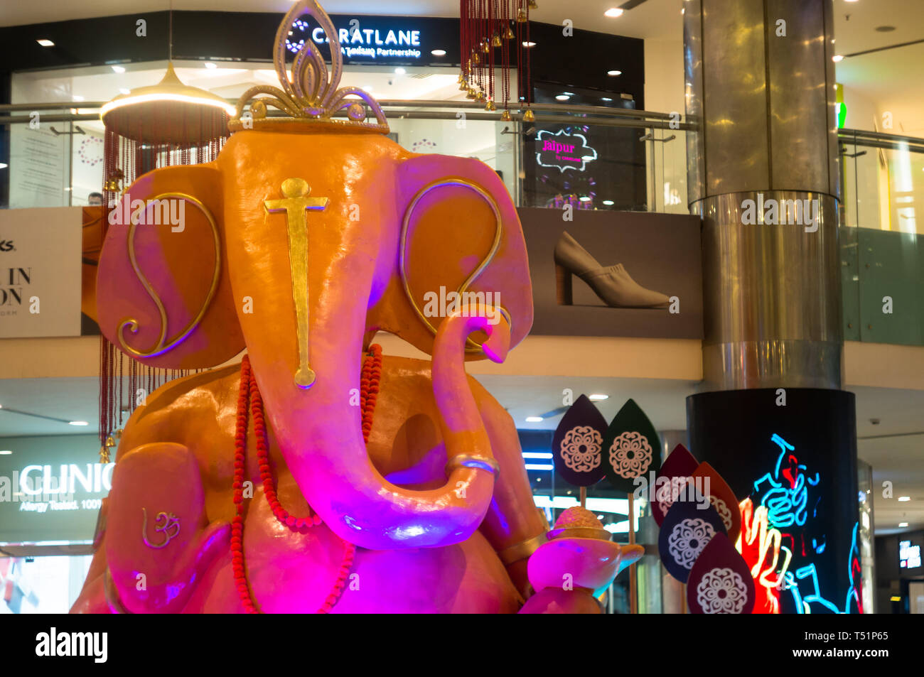 Delhi, India - Circa 2019 : Massive statue of hindu god ganesha on the eve of Ganesh Chaturti. The new shopping malls with multiple brand outlets are  Stock Photo