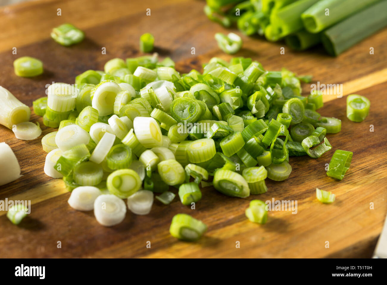 Raw Organic Chopped Green Onions on a Cutting Board Stock Photo - Alamy