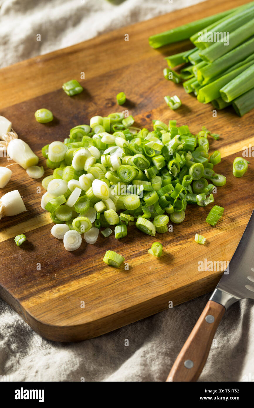 Raw Organic Chopped Green Onions on a Cutting Board Stock Photo - Alamy