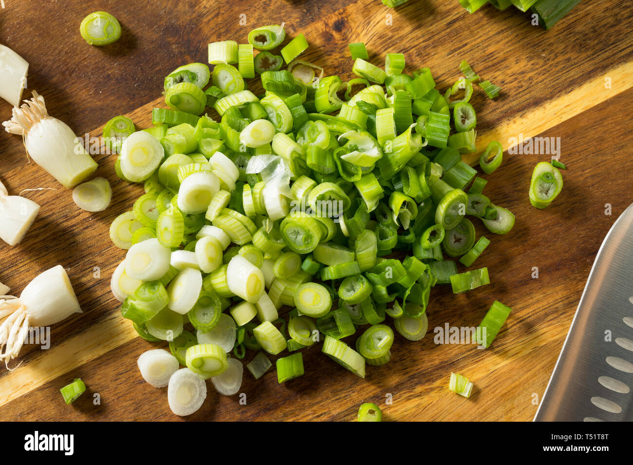 Raw Organic Chopped Green Onions on a Cutting Board Stock Photo - Alamy