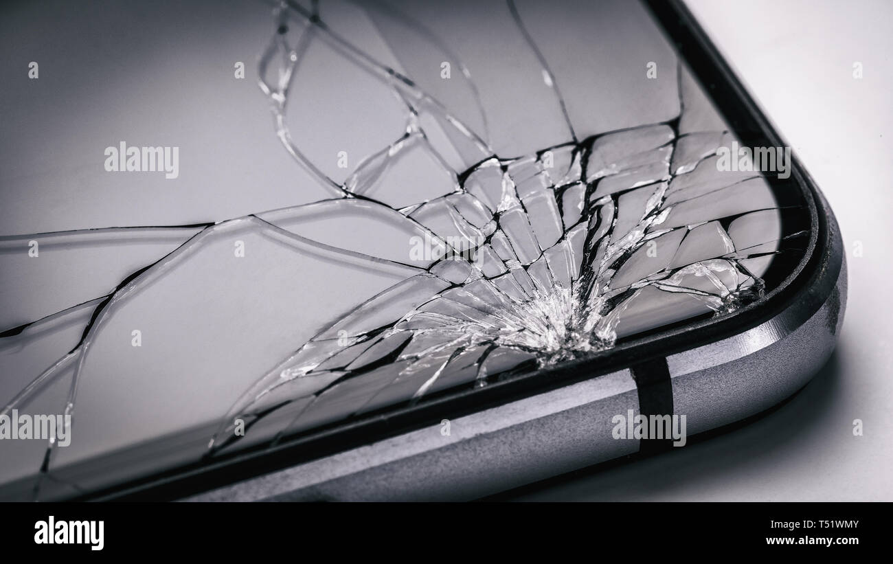Broken mobile phone screen close up. Weak glass in modern gadgets Stock Photo