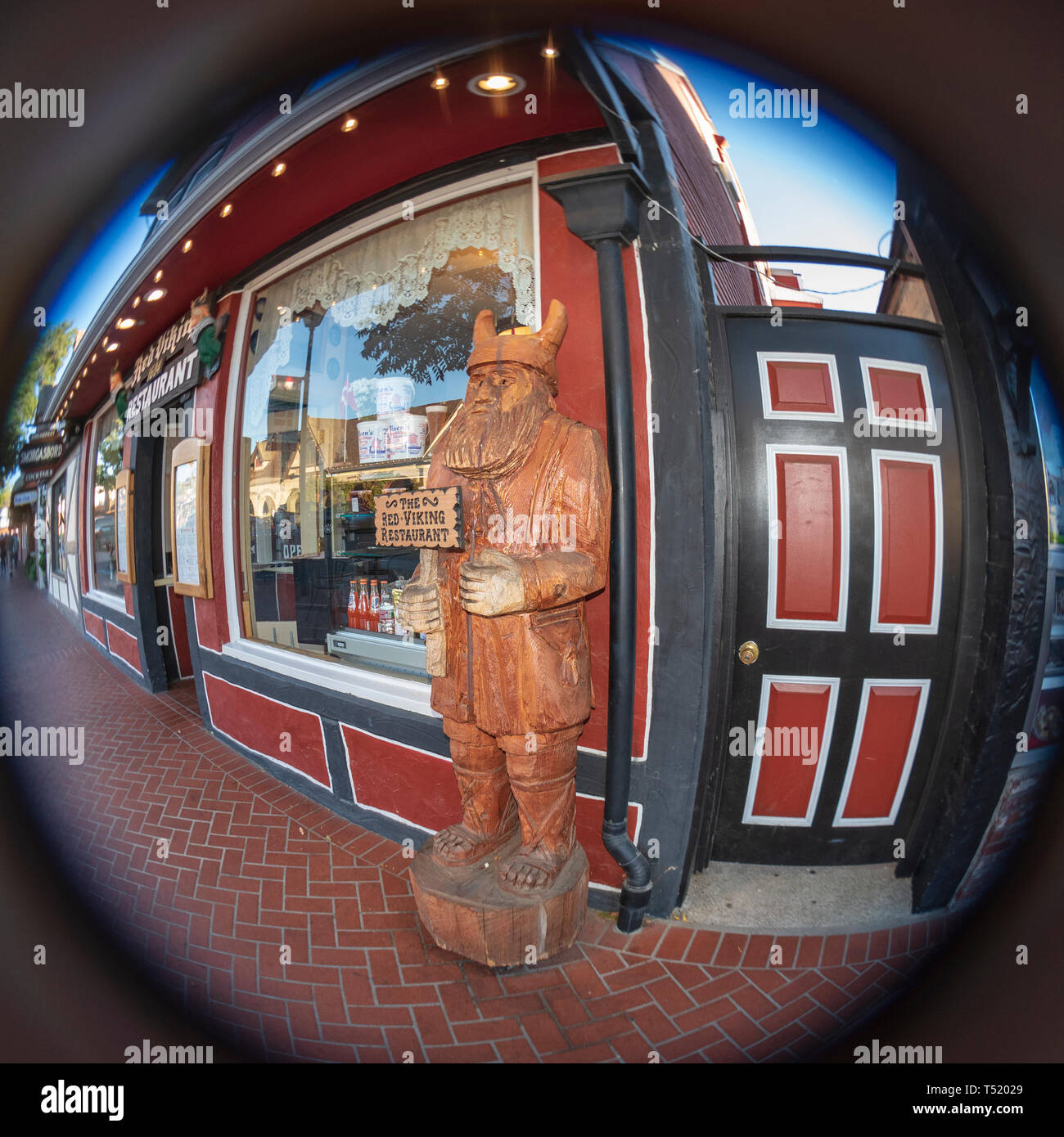 Hand carved wooden viking holding "The Red Viking Restaurant", about 5-1/2 fest tall. Viking statue in front of business next to window and entrance Stock Photo - Alamy