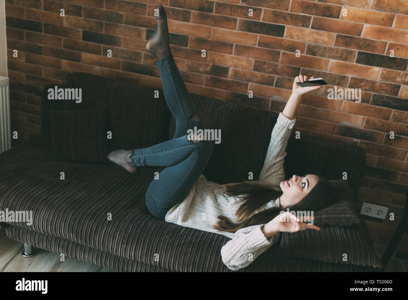 Teen girl laying on sofa hi-res stock photography and images - Alamy